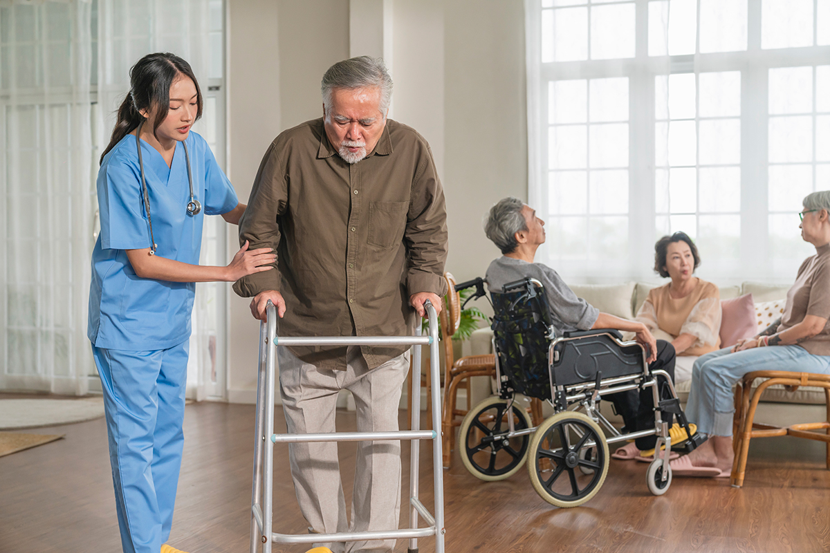 young asian female nurse care giver helping asian senior old man with mobility walker living area nursing home senior daycare center nurse take care elderly patient with cheerful concentrate